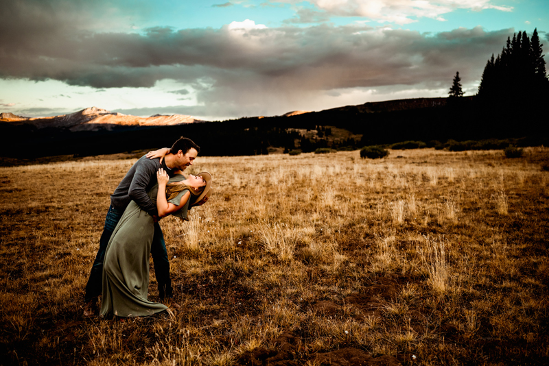 Elopement Photographer, husband dips his wife as they dance in a meadow